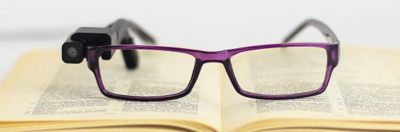 Brille mit Orcam lm rechten Bügel iegt auf einem Buch